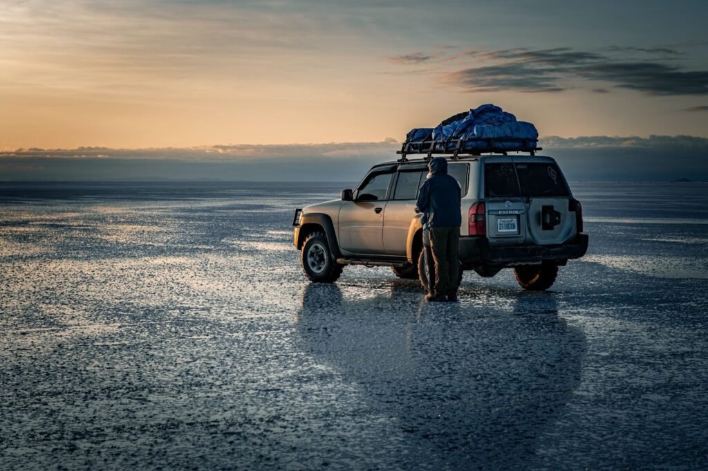 "4 Essential Tips for Cleaning and Maintaining Your Roof Rack" 1 couple standing by a jeep in wet flat landscape