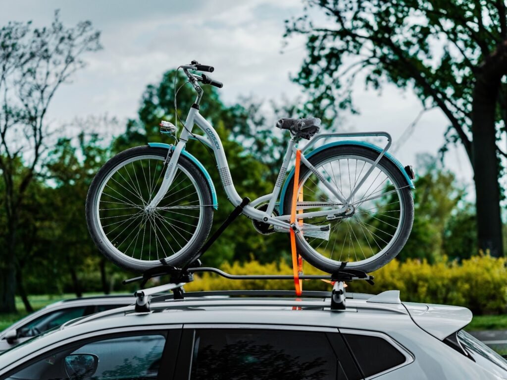 "4 Essential Tips for Cleaning and Maintaining Your Roof Rack" 2 a bicycle on top of a car in a parking lot